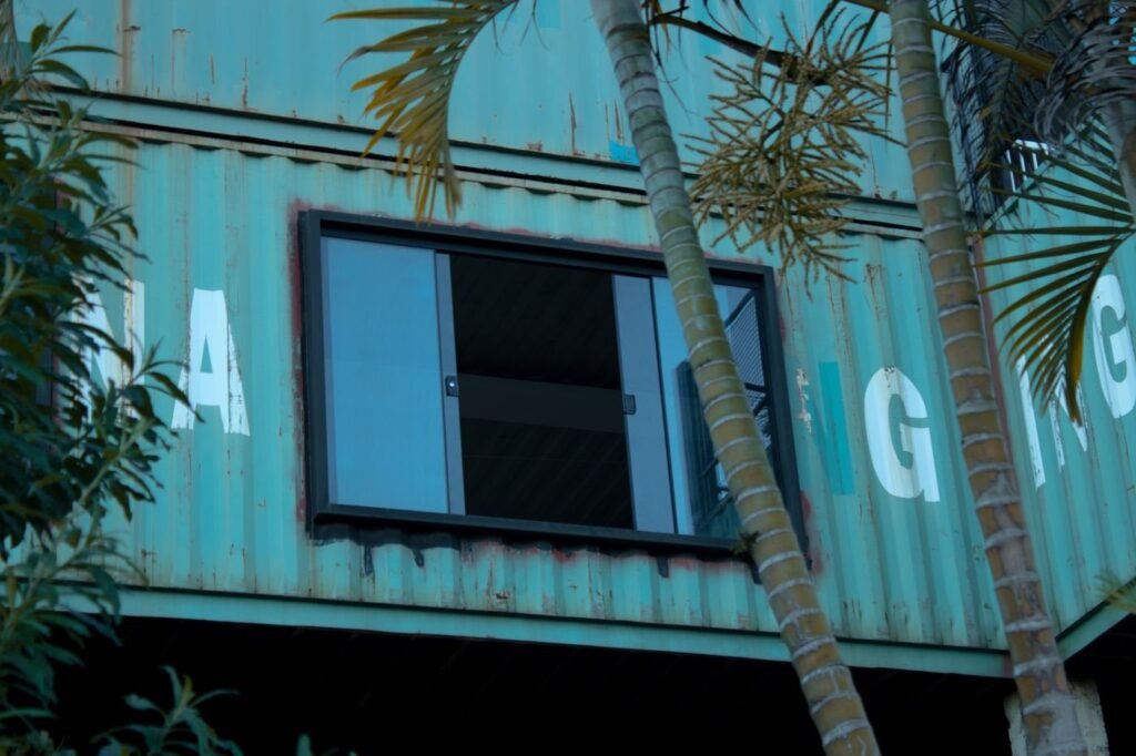 Container studio among palm trees