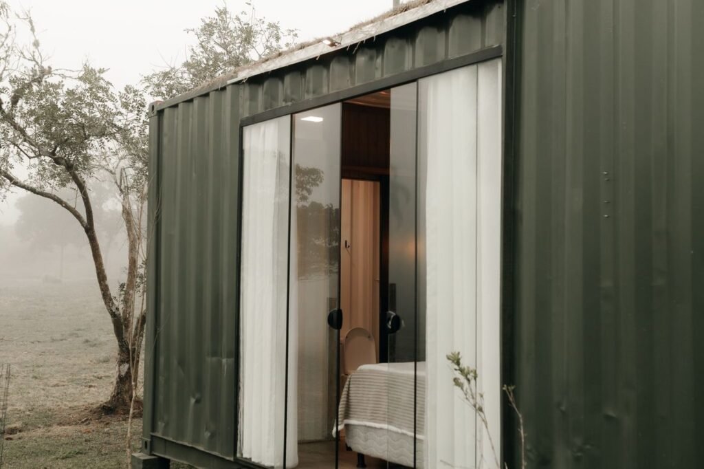 Container cabin in a misty valley